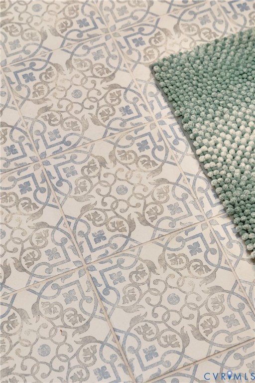 Ceramic floor tile featuring an intricate blue and grey patterned motif