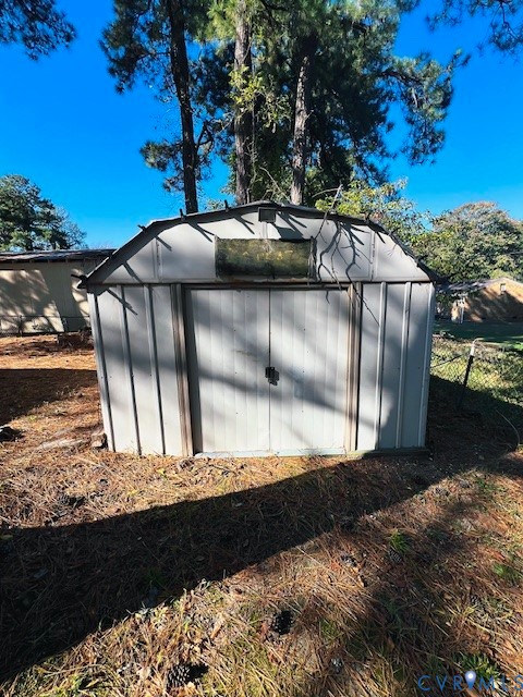 Metal storage shed with a gambrel roof and double-door entry