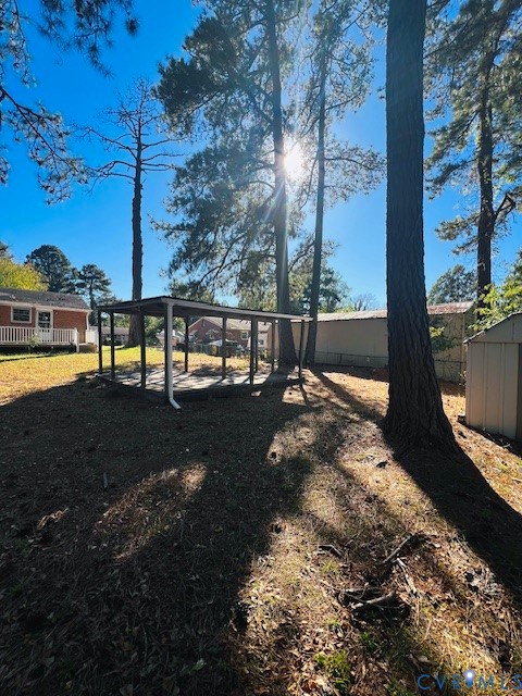 Expansive lot featuring mature trees, an open-sided pavilion, and a detached storage structure