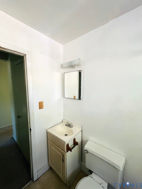 Compact vanity featuring a rectangular basin, integrated storage cabinet, wall-mounted mirror, and polished metal light fixture