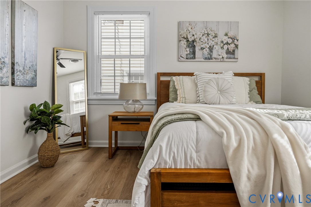 Wood-finish flooring and a single-hung window with white millwork casing