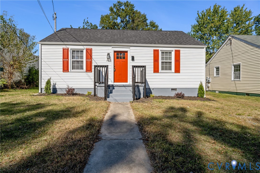 Single-story exterior featuring horizontal siding, contrasting shutters, asphalt shingle roofing, and a concrete entry path leading to a raised landing Single-story exterior featuring horizontal siding, contrasting shutters, asphalt shingle roofing, and a concrete entry path leading to a raised landing