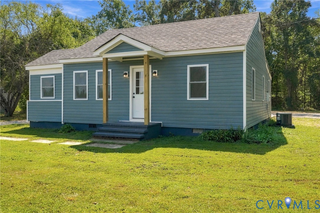 Exterior featuring blue horizontal siding, a gabled roofline, covered front entryway with wood-finish support posts, and double-hung windows Exterior featuring blue horizontal siding, a gabled roofline, covered front entryway with wood-finish support posts, and double-hung windows