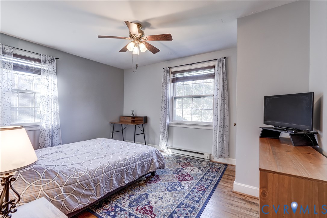 Room featuring neutral-toned walls, dual windows with multi-pane glass, and wood-finish flooring