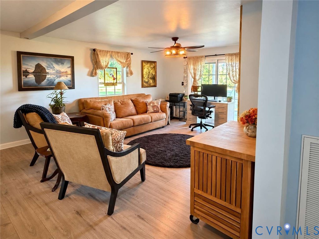 Wood-finish flooring, multi-pane windows, and ceiling fan with integrated lighting
