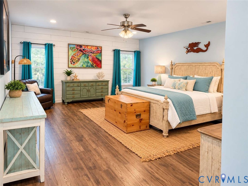 Room featuring wood-finish flooring, horizontal shiplap wall accent, recessed lighting, and a brushed nickel ceiling fan with integrated lighting