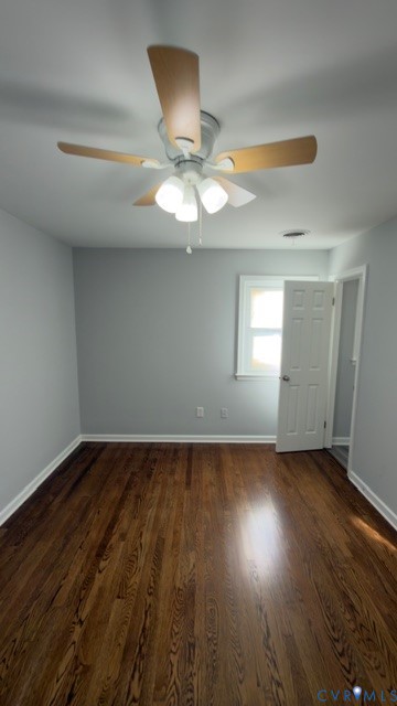 Wood-finish flooring, ceiling fan with integrated multi-bulb light fixture, and six-panel interior door