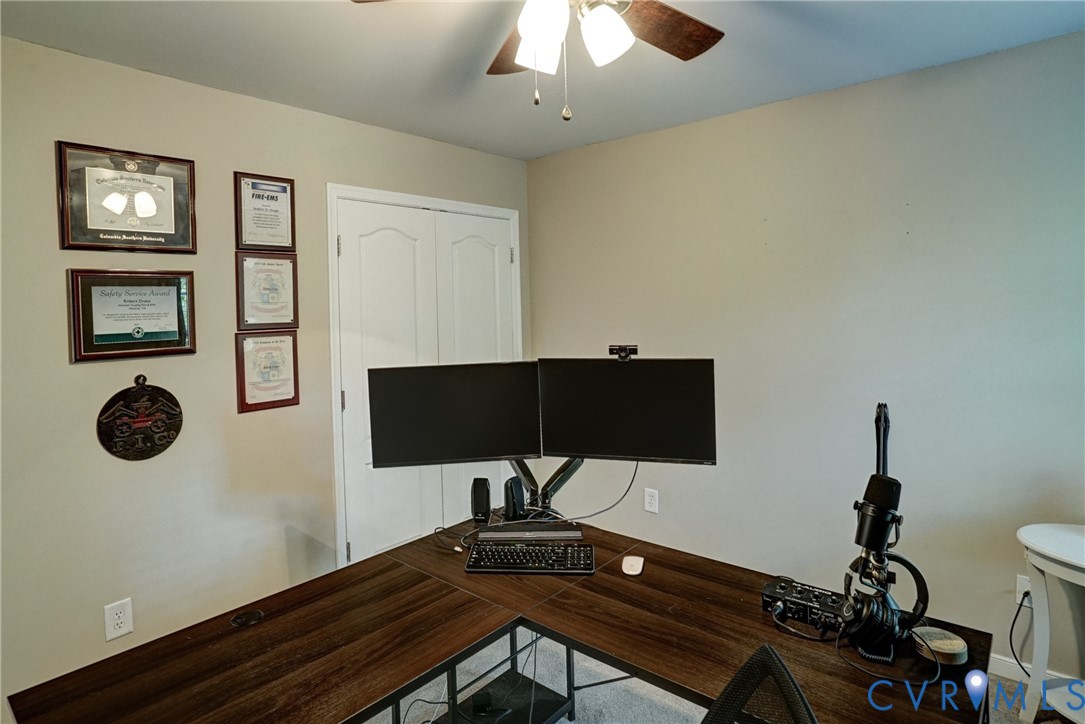 Room featuring a ceiling fan with integrated lighting and double-panel closet doors