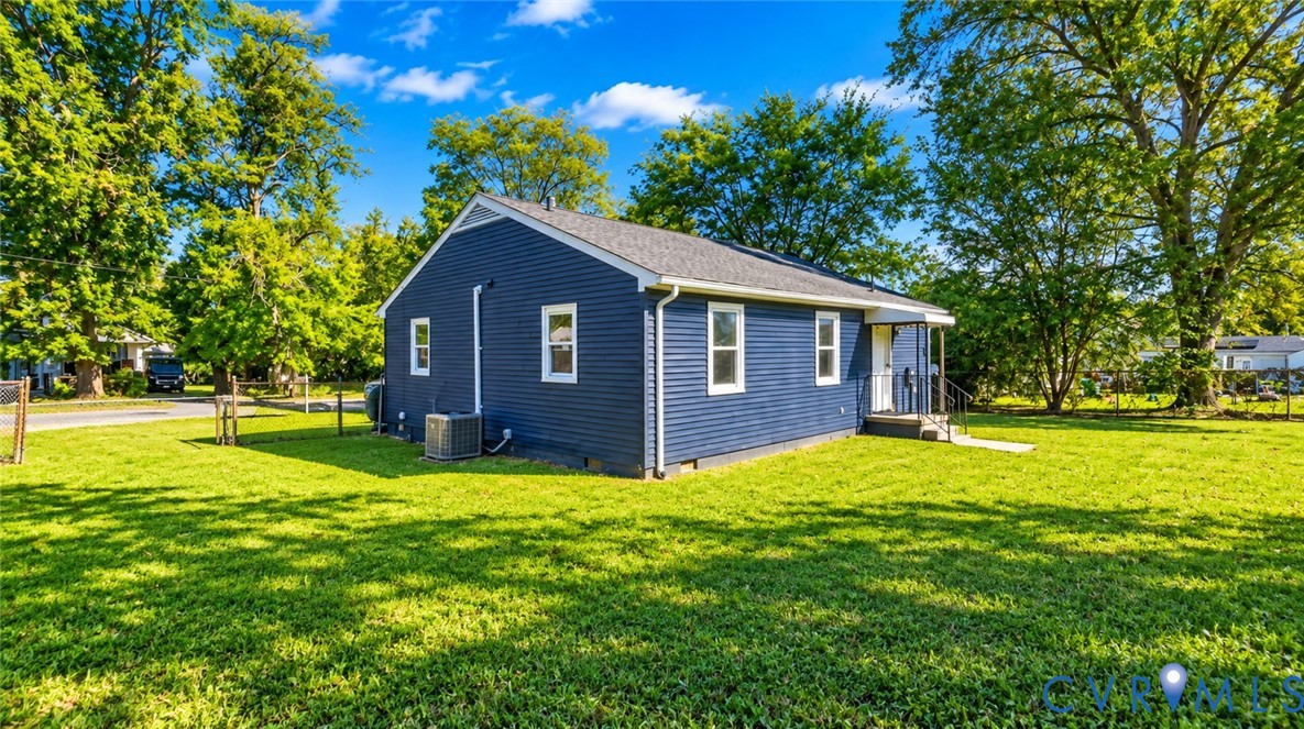 Blue horizontal siding exterior with a gable roof, white trim, and a fenced yard