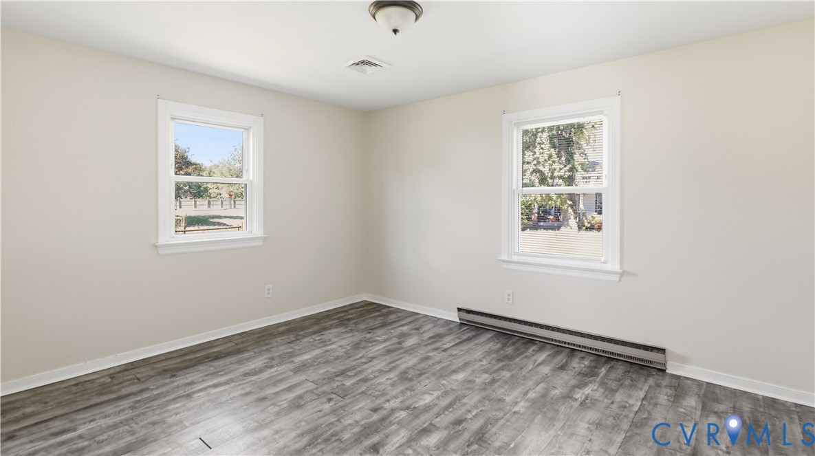 Neutral wall tones, wood-finish flooring, and double-hung windows
