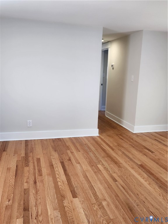 Neutral wall tones paired with polished wood-finish flooring