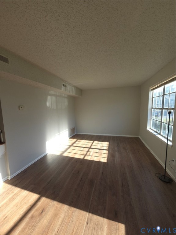 Wood-finish flooring, neutral wall tones, and large grid-pattern windows Wood-finish flooring, neutral wall tones, and large grid-pattern windows