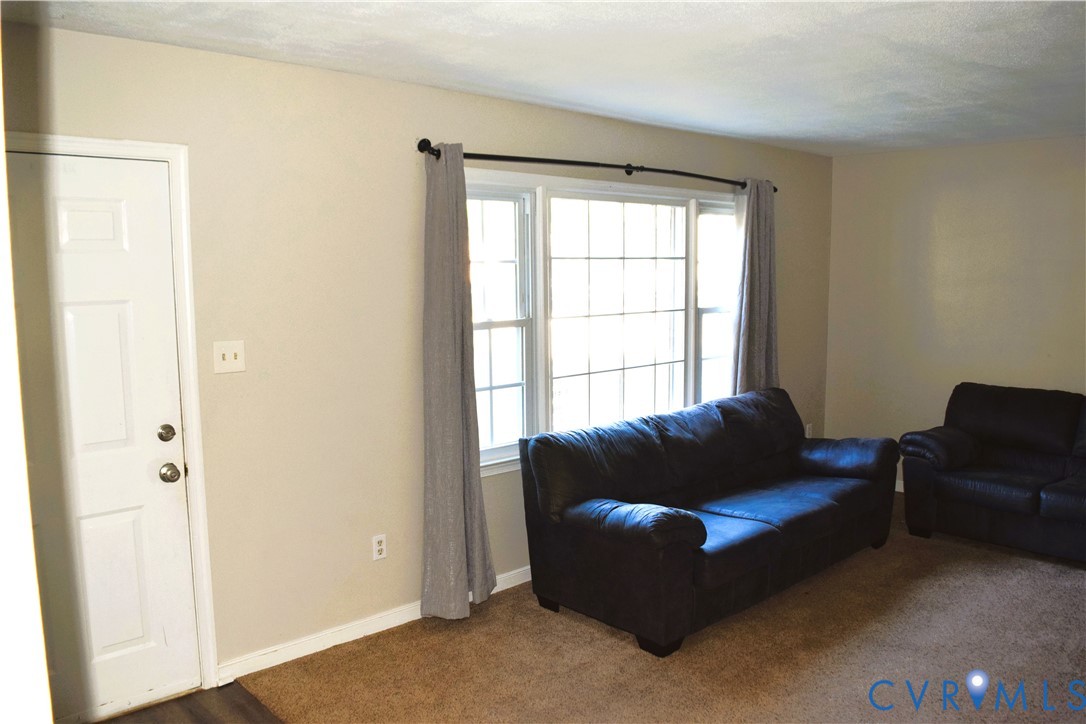 Neutral wall tones, multi-pane window configuration, and six-panel interior door