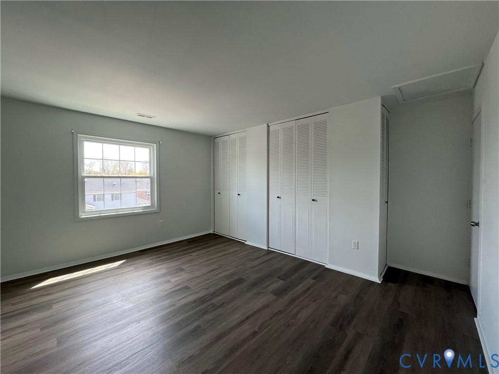 Wood-finish flooring, multi-pane window, and triple-panel louvered closet doors