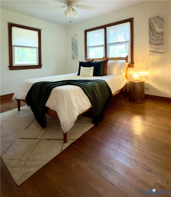 Hardwood flooring, wood-framed windows, and a ceiling-mounted light fixture