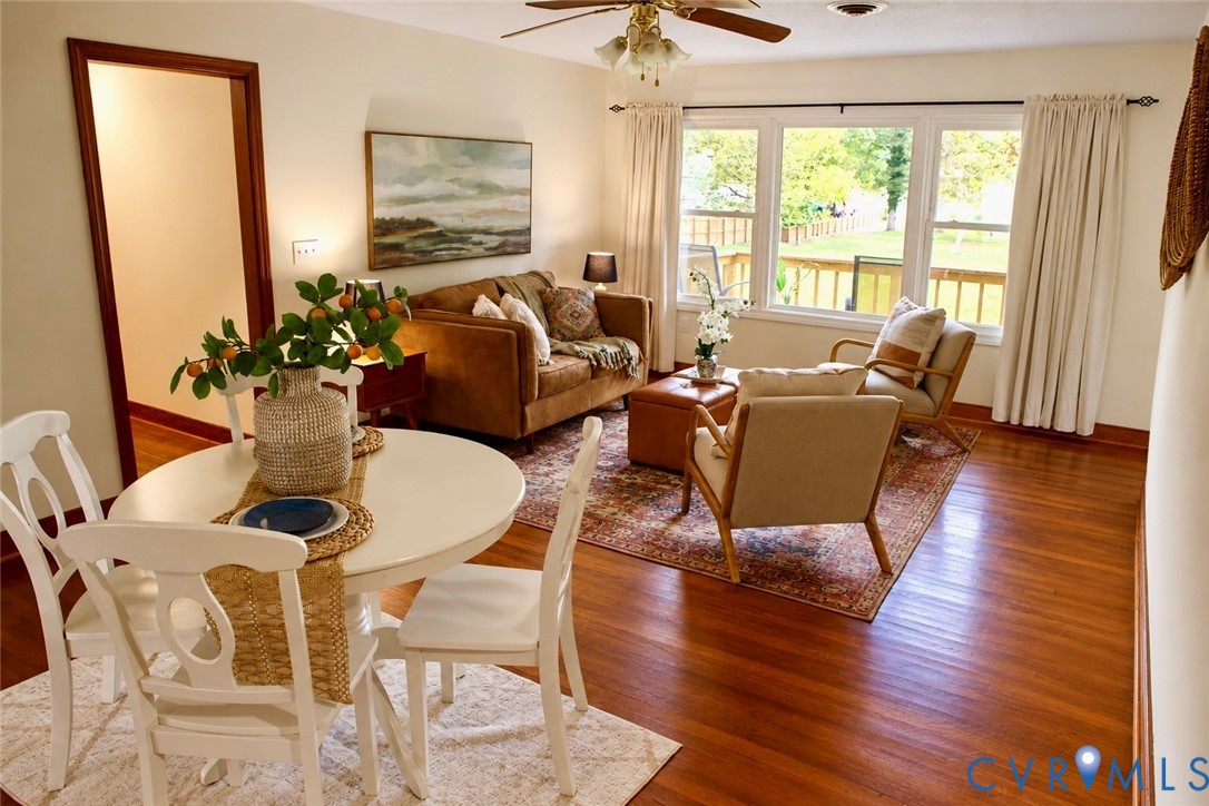 Wood-finish flooring, oversized picture window, and ceiling-mounted light fixture