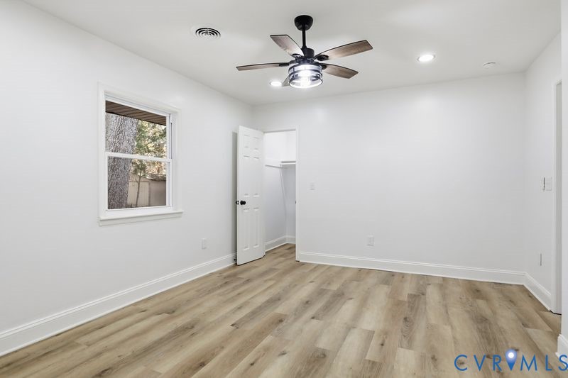 Wood-finish flooring, recessed lighting, and a ceiling fan with integrated light fixture