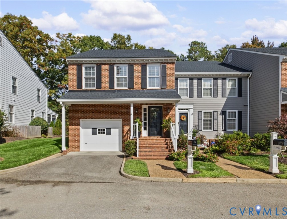 Traditional brick facade featuring decorative shutters, multi-pane windows, a single-car garage, and brick-stepped entryway Traditional brick facade featuring decorative shutters, multi-pane windows, a single-car garage, and brick-stepped entryway