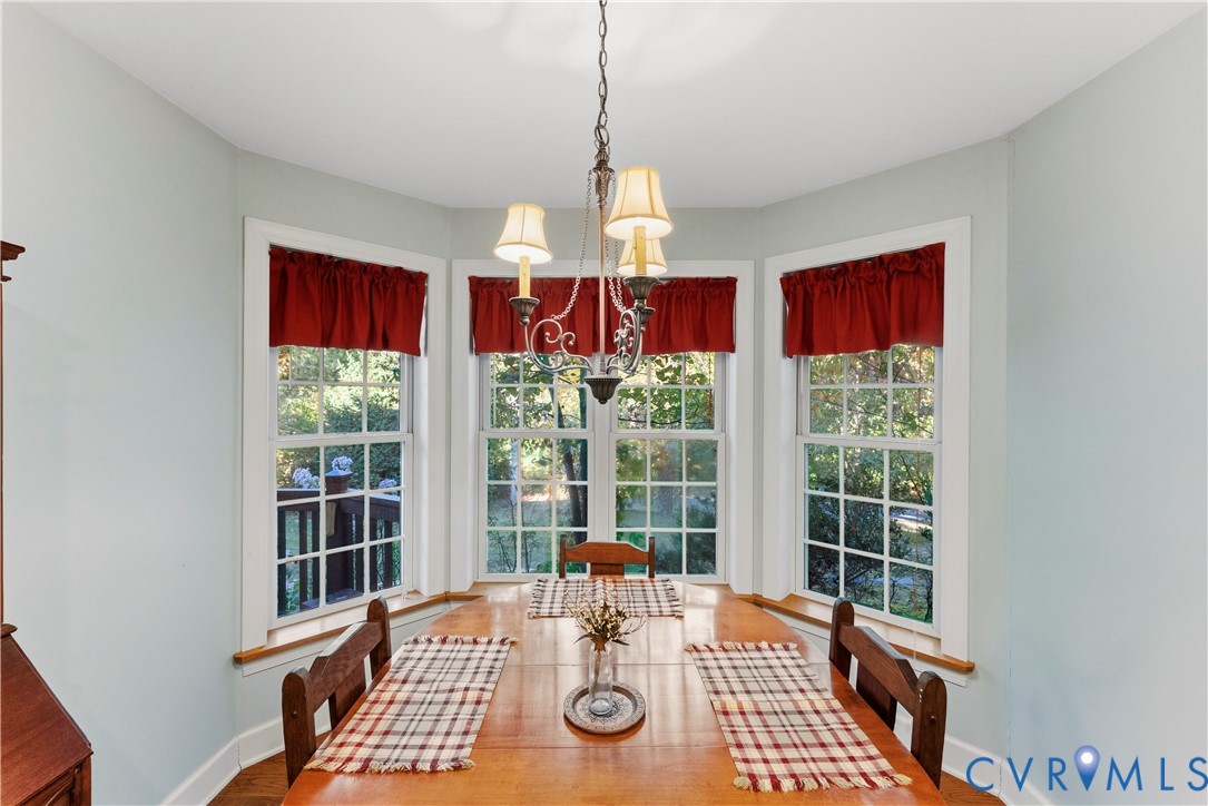 Bay window featuring multiple-pane windows, wood-finish sills, and a multi-arm metal chandelier