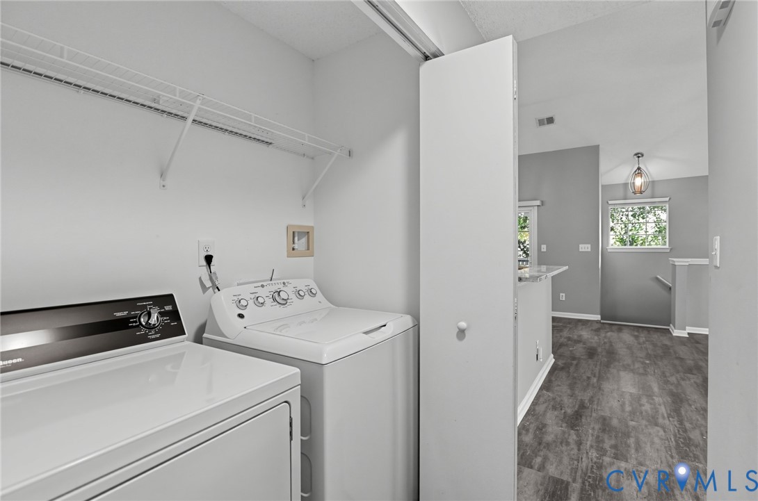 Dedicated laundry closet featuring wire shelving and wood-finish flooring