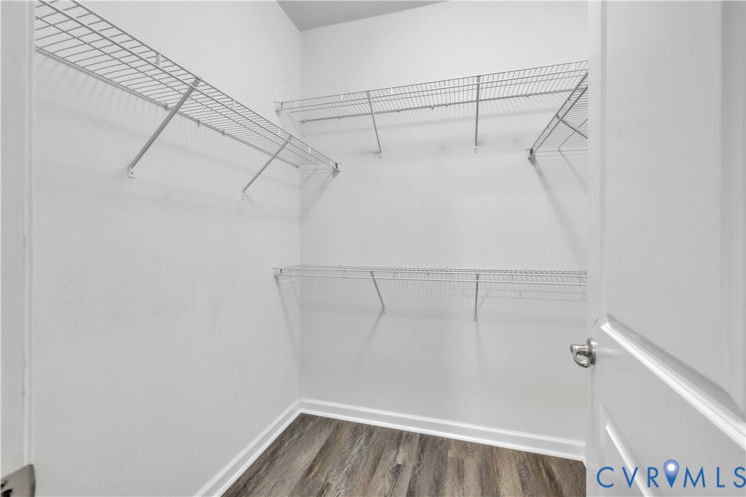Storage area featuring multi-level wire shelving and wood-finish flooring