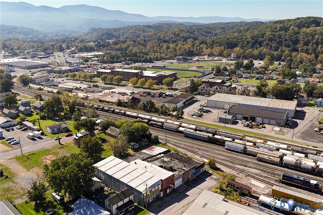 Aerial perspective featuring expansive mountain range backdrop and surrounding mixed-use development