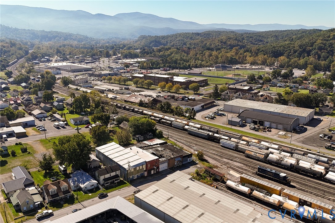 Aerial perspective showcasing mountain range topography and surrounding industrial landscape