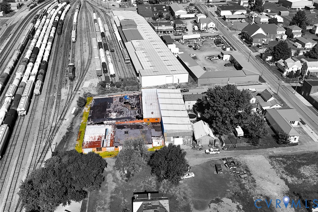 Industrial property featuring a low-slope roof, masonry exterior walls, and immediate rail line access