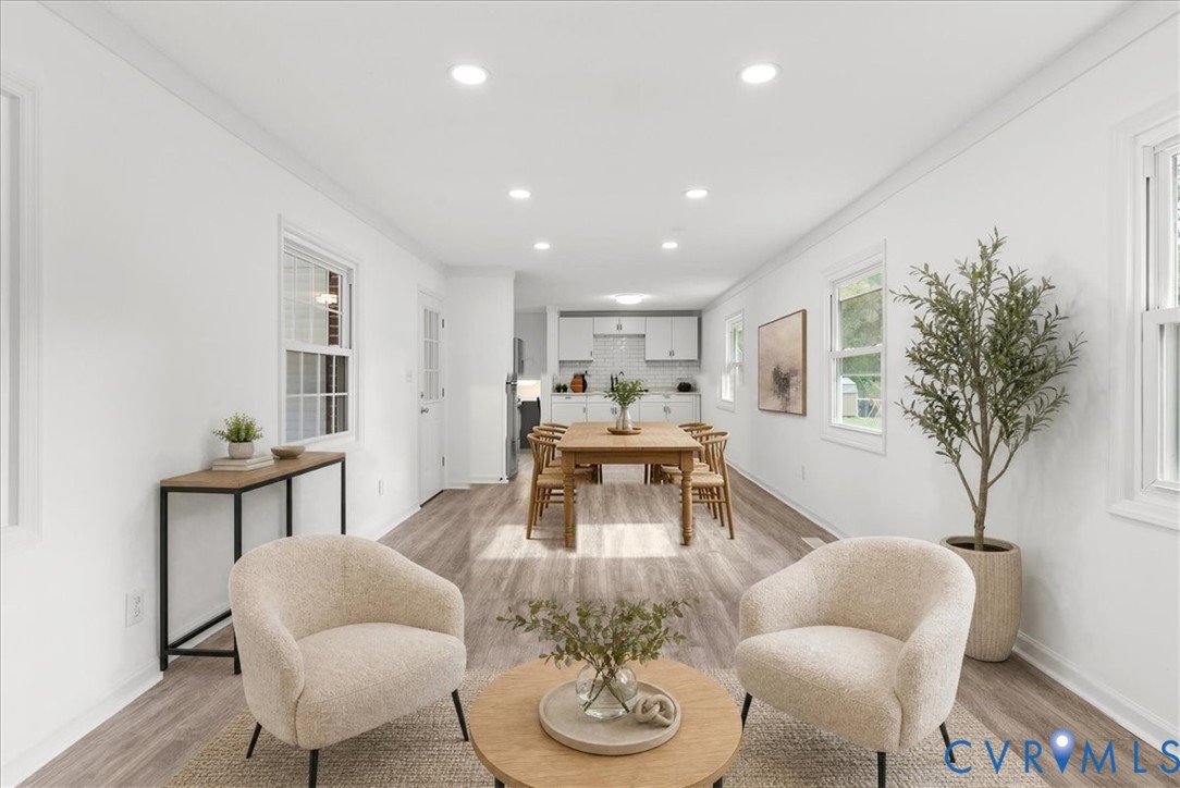 Open-concept interior featuring wood-finish flooring, recessed lighting, and multiple windows