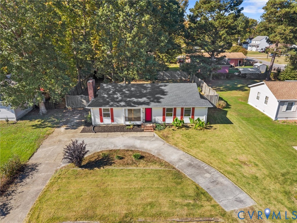 Ranch-style residence featuring white siding, red shutters, a brick exterior chimney, asphalt shingle roofing, and a curved concrete driveway Ranch-style residence featuring white siding, red shutters, a brick exterior chimney, asphalt shingle roofing, and a curved concrete driveway