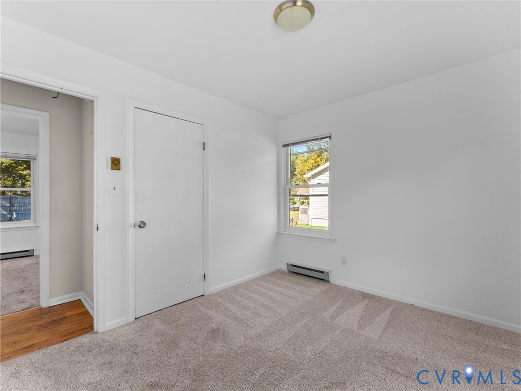 Room featuring wall-to-wall carpeting, a single-hung window, and a flush-mount ceiling light fixture