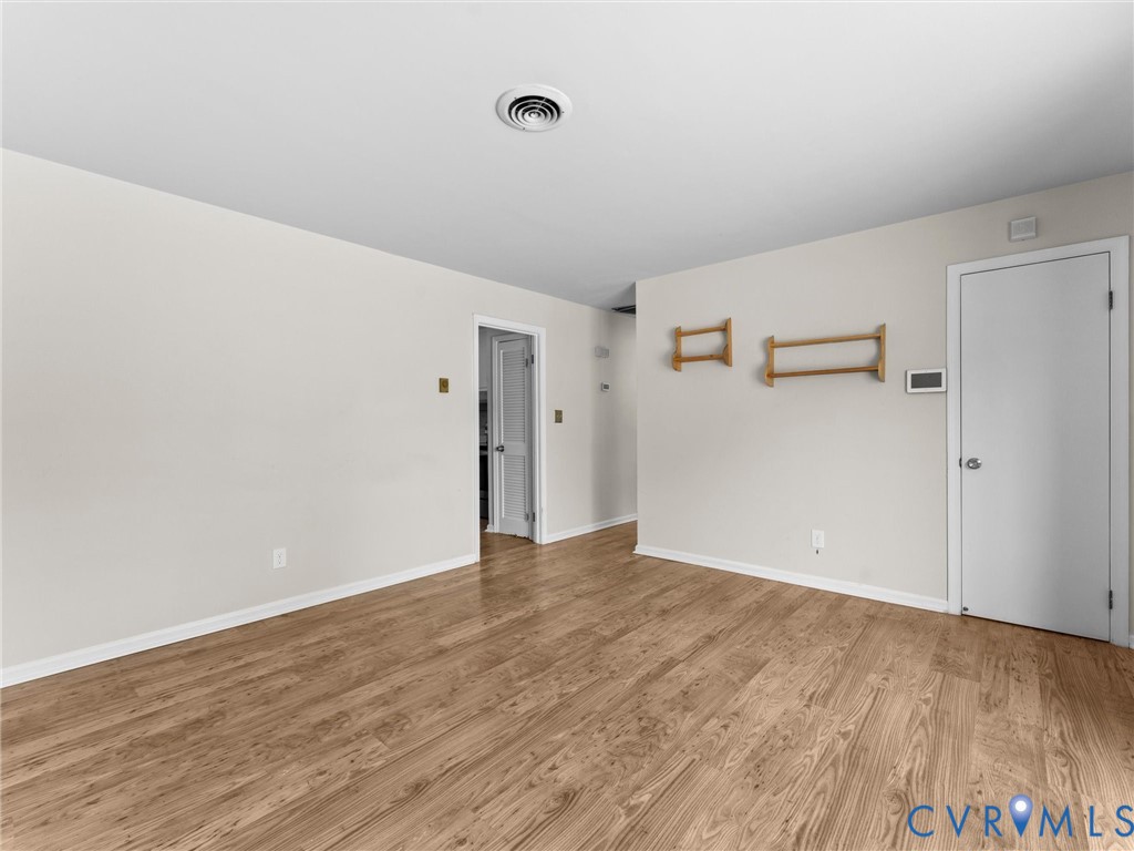 Neutral interior walls, wood-finish flooring, and solid-core interior doors