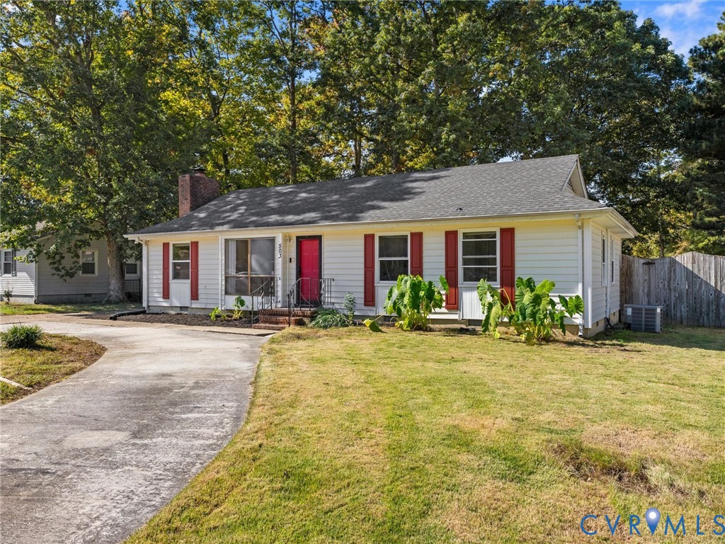 Single-story exterior featuring white horizontal siding, red shutters, a brick chimney, and a concrete driveway Single-story exterior featuring white horizontal siding, red shutters, a brick chimney, and a concrete driveway