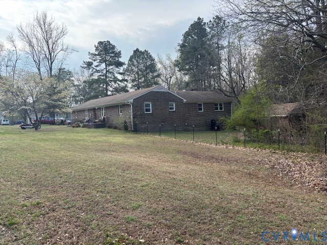 Single-story brick exterior residence featuring a spacious lot, mature trees, and a detached storage structure Single-story brick exterior residence featuring a spacious lot, mature trees, and a detached storage structure
