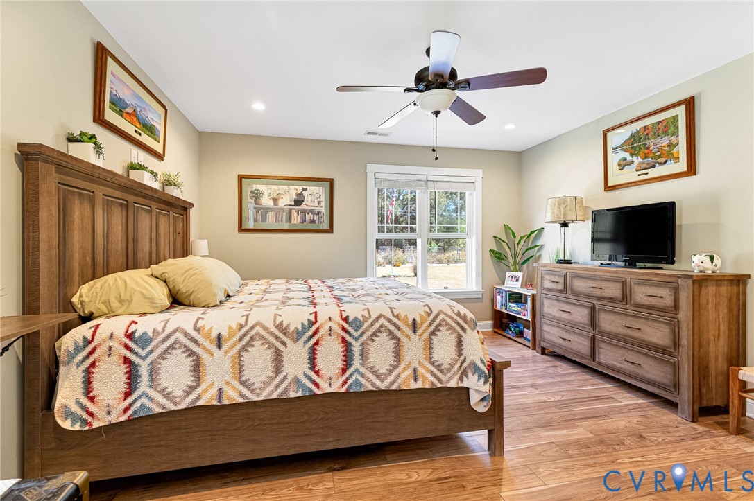 Bedroom featuring wood-finish flooring, recessed lighting, and a central ceiling fan