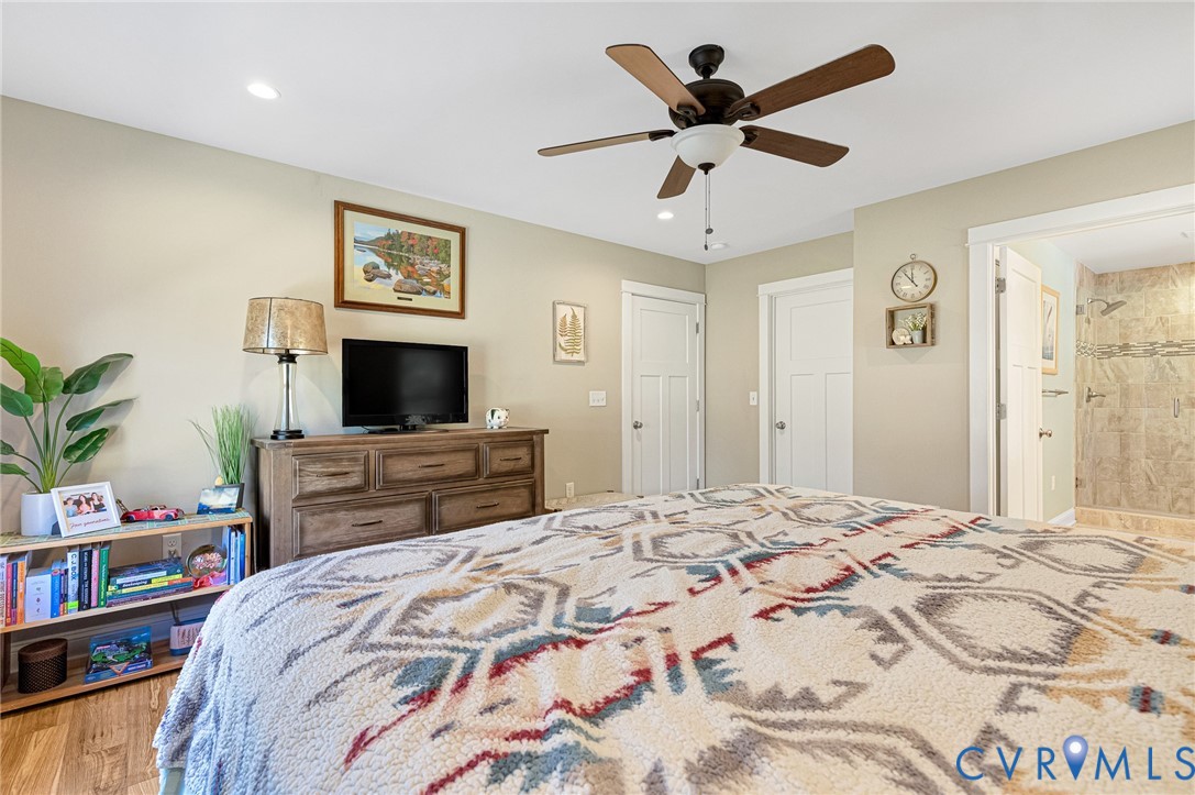 Bedroom featuring recessed lighting, a multi-blade ceiling fan, and paneled interior doors