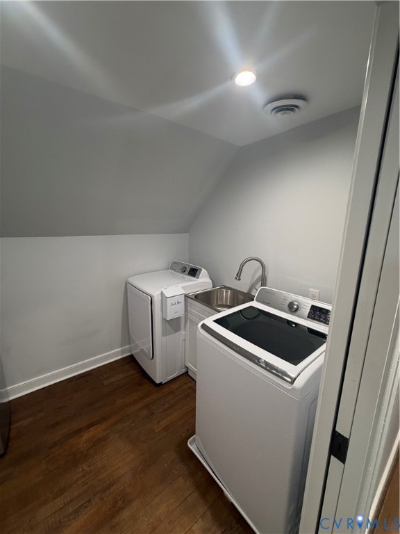 Laundry area featuring wood-finish flooring, a stainless steel sink with a goose-neck faucet, and built-in cabinetry Laundry area featuring wood-finish flooring, a stainless steel sink with a goose-neck faucet, and built-in cabinetry