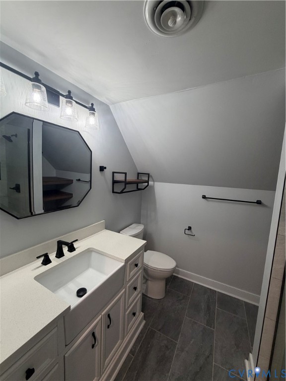 Bathroom featuring a farmhouse-style apron sink, matte black fixtures, an octagonal mirror, built-in shelving, and tile flooring Bathroom featuring a farmhouse-style apron sink, matte black fixtures, an octagonal mirror, built-in shelving, and tile flooring