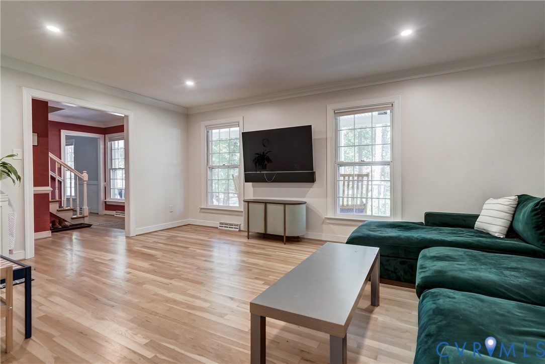 Wood-finish flooring, recessed lighting, and multiple double-hung windows