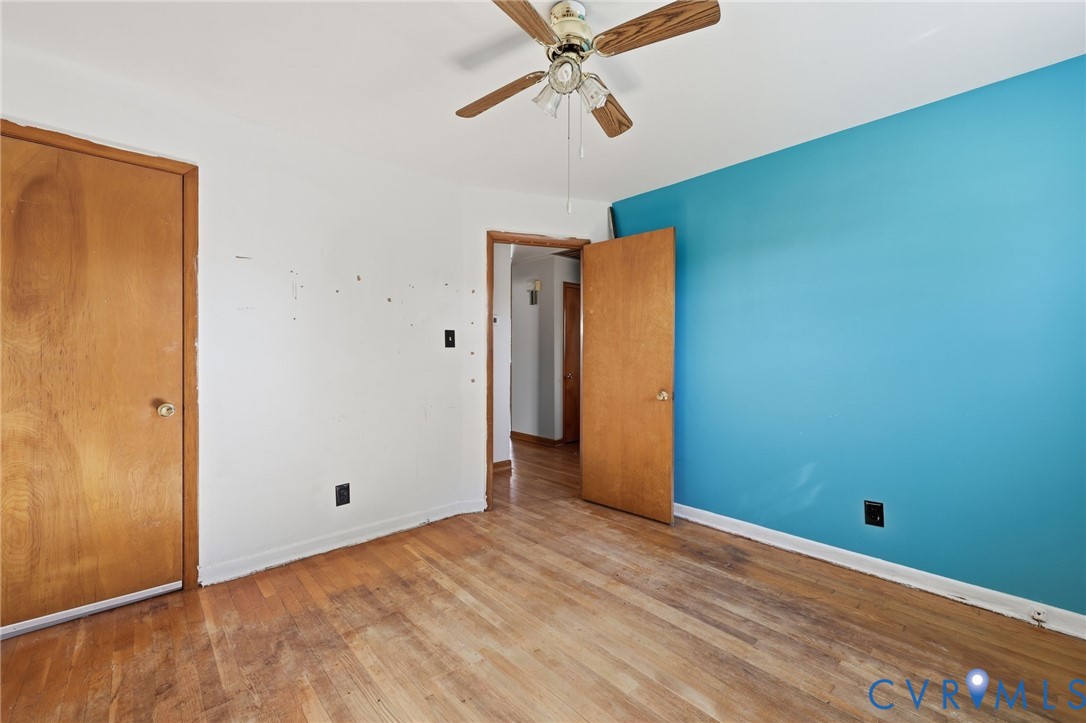 Wood-finish flooring, ceiling fan with integrated lighting, and solid core wood-finish interior doors