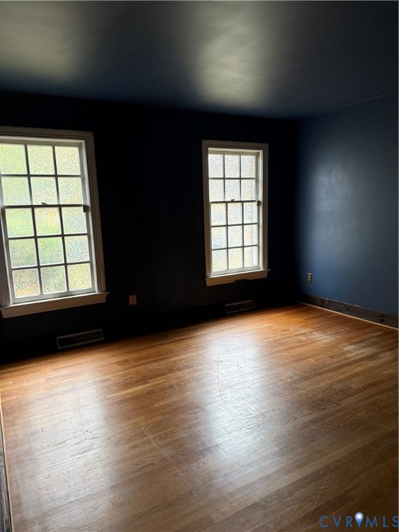 First Floor Bedroom Room featuring wood-finish flooring and two multi-pane windows with grid detailing