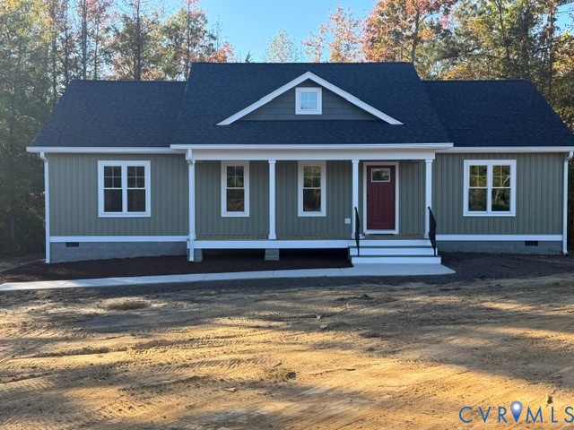 Board-and-batten siding exterior featuring a covered front porch with square columns, a gable roofline, and a concrete walkway