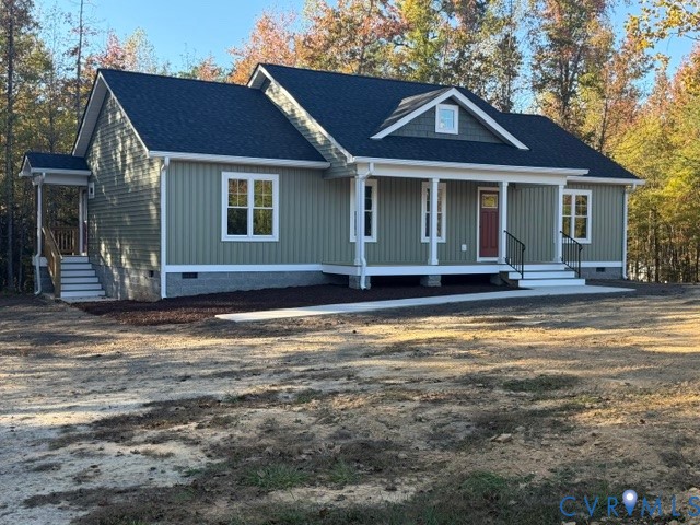 Exterior featuring vertical siding, a covered front porch with columns, a gable roofline, and masonry foundation skirting