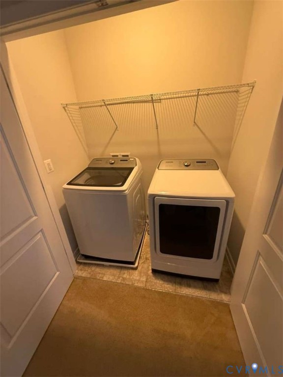 Enclosed laundry area featuring dual appliance hookups and a built-in wire shelving system