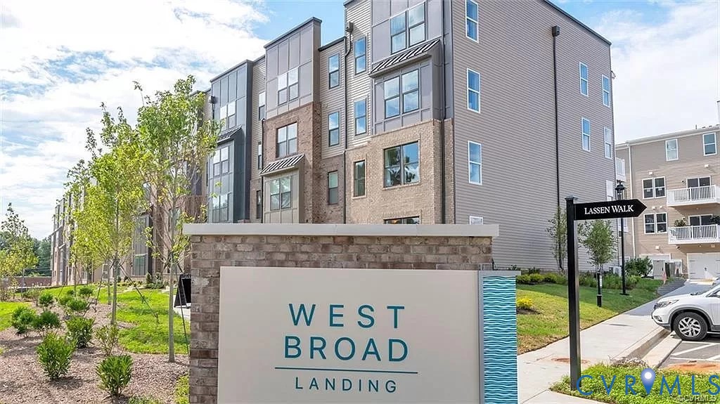 Multi-story exterior featuring a mix of brick and siding facades, metal panel accents, and a landscaped grounds area with mature trees and shrubbery Multi-story exterior featuring a mix of brick and siding facades, metal panel accents, and a landscaped grounds area with mature trees and shrubbery