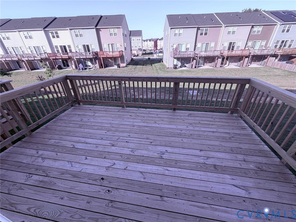 Elevated wood deck featuring vertical baluster railings and open-air design