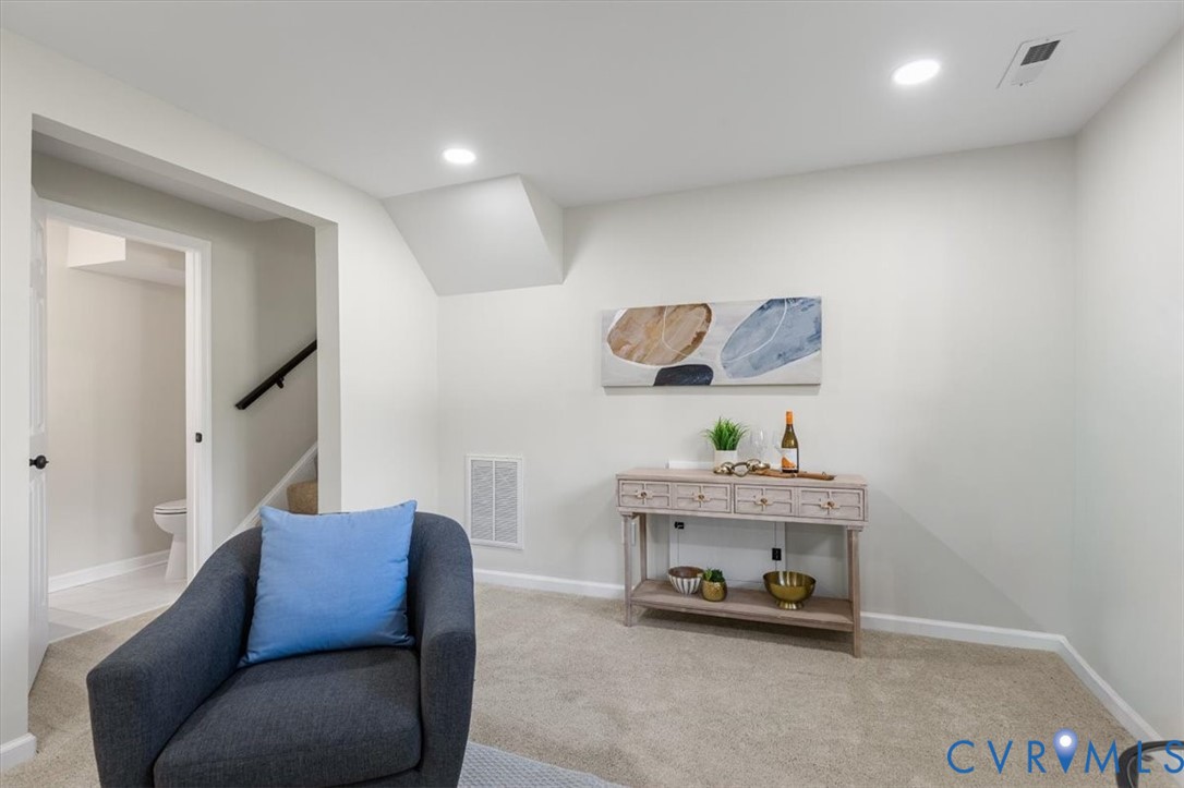 Neutral-toned interior space featuring recessed ceiling lighting and wall-to-wall carpeting