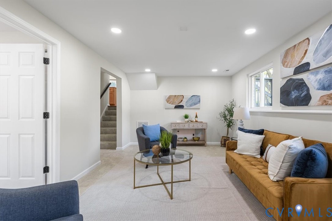 Neutral-toned interior featuring recessed lighting, carpeted flooring, and a six-panel door