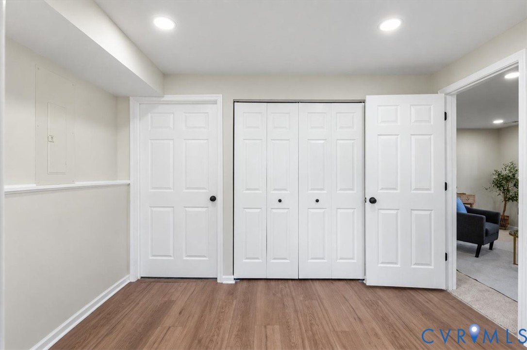 Wood-finish flooring, six-panel interior doors, bi-fold closet doors, and recessed lighting