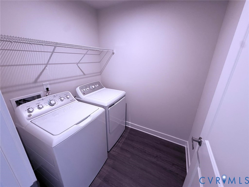 Laundry area featuring wood-finish flooring and integrated wire shelving